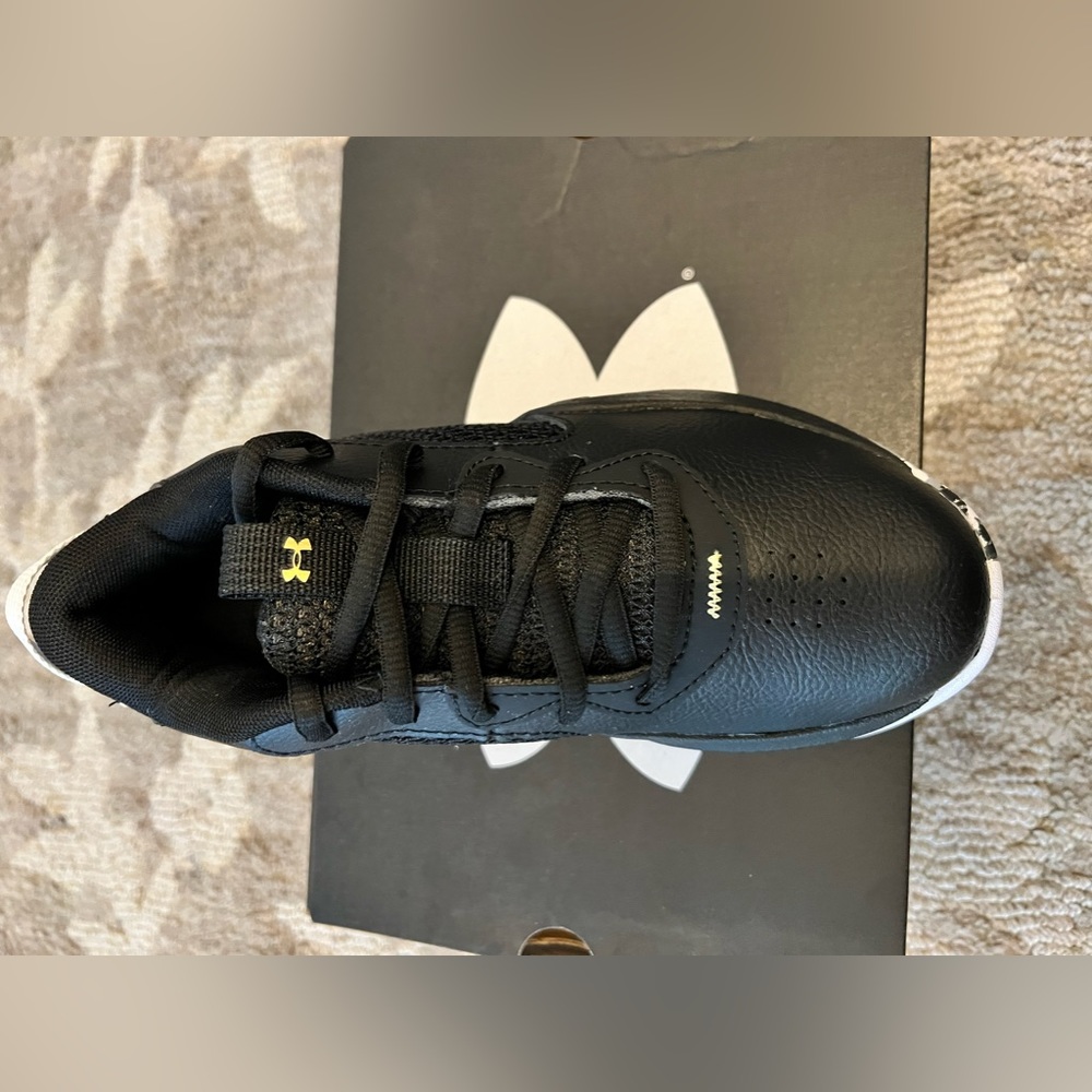 Black, white and gold boys Under Armour tennis shoes